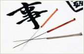 three acupuncture Needles spread across Chinese character